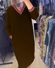 Elegancka sukienka z dekoltem w kształcie litery V i kieszeniami